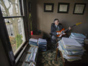 Michael Green, a Vancouver criminal defense attorney and musician, is pictured in his downtown office. Green will often take a break from his caseload for a quick jam session to help clear his mind and refocus.