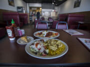 The chicken gyro plate, clockwise from center, is served with baklava and the iskender plate at  I Heart Gyro.