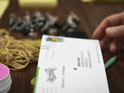 Workers open and sort ballots at the Clark County Elections Office on Wednesday.