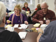 Margie Brown, left, and Gary McMann open and sort ballots at the Clark County Elections Office on Wednesday. About 180,000 registered voters are eligible to participate in this February&#039;s special election.