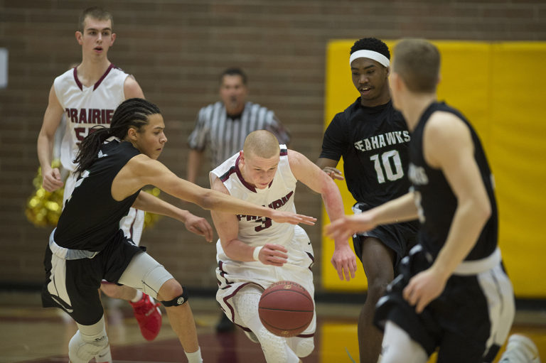 Peninsula's Elijah McLaughlin (2) battle Prairie's at Kameron Osborn (3) for a loose ball as Debore'ae McClain (10) looks on in the first quarter at Prairie High School on Wednesday night, Feb. 8, 2017.