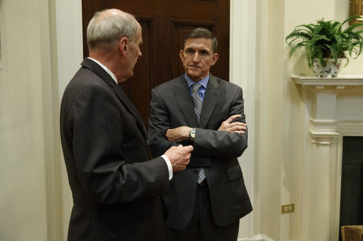 National Security Adviser Mike Flynn, right, talks with Ret. Gen. Keith Alexander before a meeting with President Donald Trump on cyber security in the Roosevelt Room of the White House in Washington, Tuesday, Jan. 31, 2017.