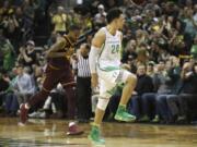 Oregon's Dillon Brooks, right, celebrates after shooting a 3-point shot in the closing minutes, as Arizona State's Torian Graham moves downcourt during an NCAA college basketball game Thursday, Feb. 2, 2017, in Eugene, Ore. Oregon won 71-70.