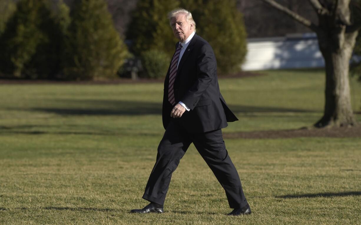 FILE - In this Thursday, Jan. 26, 2017, file photo, President Donald Trump walks on the South Lawn of the White House in Washington after returning from a trip to Philadelphia. Lawmakers in Massachusetts and other Democratic-leaning states are considering ways to flex their muscles in response to the policies of President Donald Trump. House Democrats have scheduled an unusual caucus for Wednesday, Feb. 8, 2017, at the Statehouse to discuss a response to "recent actions" by the Trump administration.