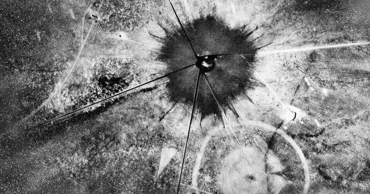 FILE - This July 16, 1945 file photo shows an aerial view after the first atomic explosion at Trinity Test Site, N.M. A report is scheduled to be released Friday, Feb. 10, 2017, on the health effects of the people who lived near the site of the world's first atomic bomb test. The Tularosa Basin Downwinders Consortium will release the health assessment report, on residents of a historic Hispanic village of Tularosa near the Trinity Test in the New Mexico desert.