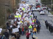 Protesters march up the hill to Rep. Dave Reichert's (R-WA) office in Issaquah Thursday, Feb. 23, 2017. Some of Reichert's constituents in the 8th District say he is avoiding them by skipping Town Hall meetings and refusing phone calls.