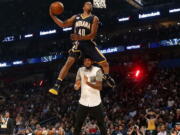 Indiana pacers Glenn Robinson III slam dunks over teammate Paul George as he participates in the slam dunk contest during NBA All-Star Saturday Night events in New Orleans, Saturday, Feb. 18, 2017.