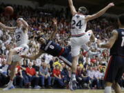 Gonzaga&#039;s Silas Melson (0) has his shot blocked by Saint Mary&#039;s Dane Pineau, left, during the second half.