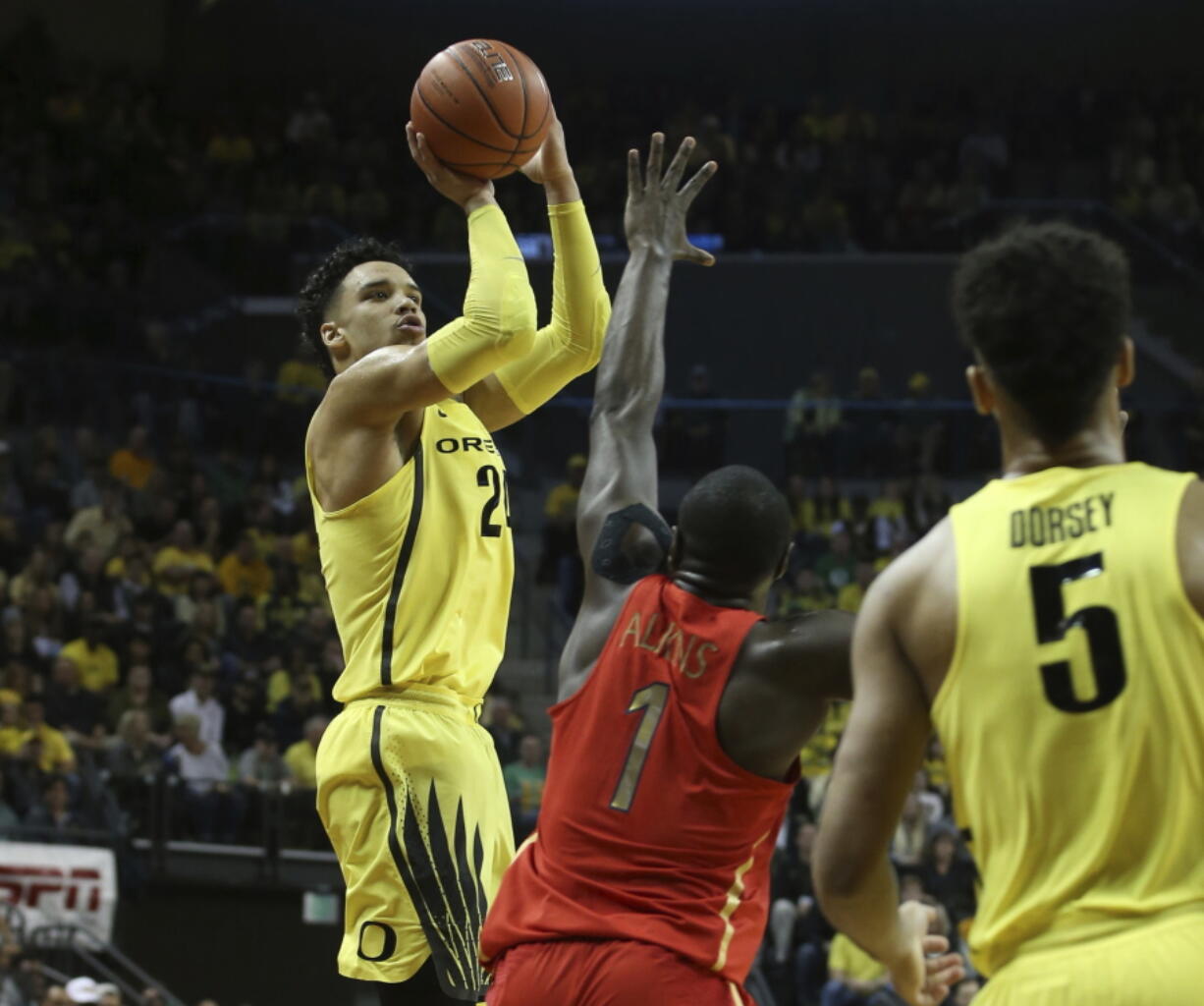 Oregon&#039;s Dillon Brooks, left, shoots a 3-point basket over Arizona&#039;s Rawle Alkins, center, with teammate Tyler Dorsey, right, watching during the first half of an NCAA college basketball game Saturday, Feb. 4, 2017, in Eugene, Ore.