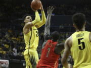 Oregon&#039;s Dillon Brooks, left, shoots a 3-point basket over Arizona&#039;s Rawle Alkins, center, with teammate Tyler Dorsey, right, watching during the first half of an NCAA college basketball game Saturday, Feb. 4, 2017, in Eugene, Ore.