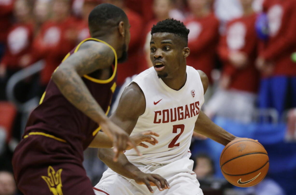 Washington State guard Ike Iroegbu (2) looks to drive around Arizona State guard Torian Graham in the first half of an NCAA college basketball game, Saturday, Feb. 18, 2017, in Pullman, Wash. (AP Photo/Ted S.