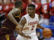 Washington State guard Ike Iroegbu (2) looks to drive around Arizona State guard Torian Graham in the first half of an NCAA college basketball game, Saturday, Feb. 18, 2017, in Pullman, Wash. (AP Photo/Ted S.