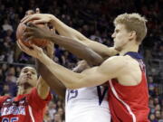 Washington&#039;s Noah Dickerson, center, battles Arizona&#039;s Keanu Pinder, left, and Lauri Markkanen for a loose ball during the first half of an NCAA college basketball game Saturday, Feb. 18, 2017, in Seattle.