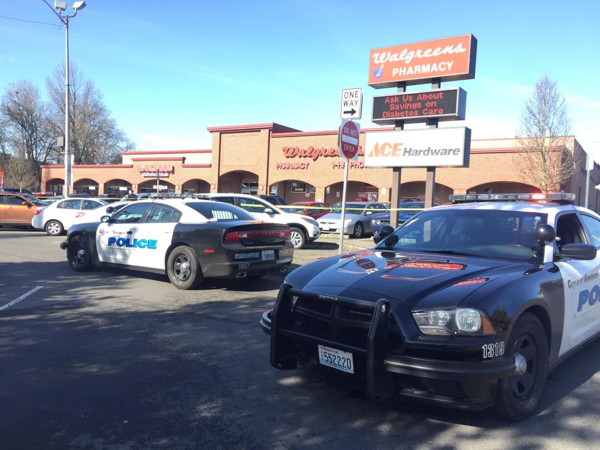 Vancouver police investigate a crime scene in Uptown Village Saturday where a wanted man tried to run over a police officer. The officer fired at the suspect.