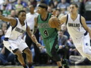 Boston Celtics guard Isaiah Thomas (4) dribbles against Dallas Mavericks defenders Yogi Ferrell (11) and Dwight Powell during the first half of an NBA basketball game in Dallas, Monday, Feb. 13, 2017.