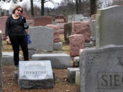 Sally Amon of Olivette, Mo., reacts as she saw toppled gravestone of her grandmother Anna Ida Hutkin at Chesed Shel Emeth Cemetery in University City, a suburb of St. Louis on Tuesday. Vandals have damaged or tipped over as many as 200 headstones at the Jewish cemetery in suburban St. Louis, leaving the region&#039;s Jewish community shaken and anxious. (Robert Cohen/St.