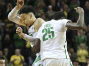 Oregon&#039;s Dillon Brooks, left, and Chris Boucher celebrate as Colorado calls timeout after a Boucher three-point shot during the second half of an NCAA college basketball game Saturday, Feb. 18, 2017, in Eugene, Ore.