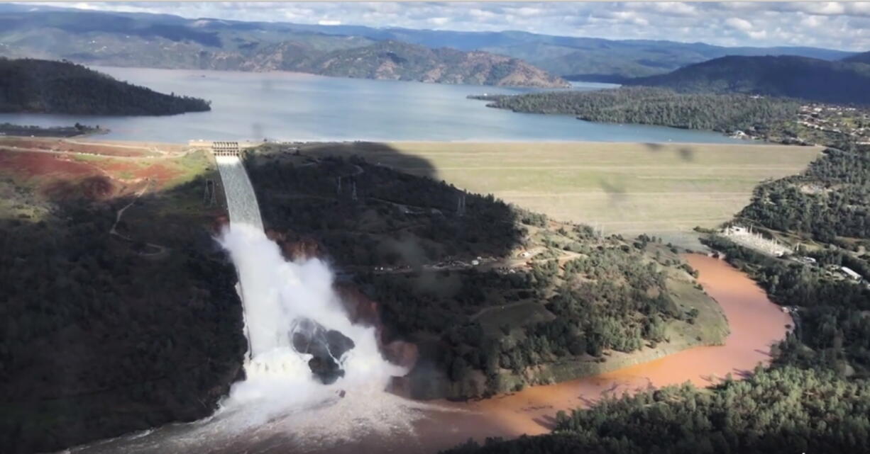 This Friday, Feb. 10, 2017 image from video provided by the office of Assemblyman Brian Dahle shows water flowing over an emergency spillway of the Oroville Dam in Oroville, Calif., during a helicopter tour by the Butte County Sheriff&#039;s office. About 150 miles northeast of San Francisco, Lake Oroville is one of California&#039;s largest man-made lakes, and the 770-foot-tall Oroville Dam is the nation&#039;s tallest. (Josh F.W.