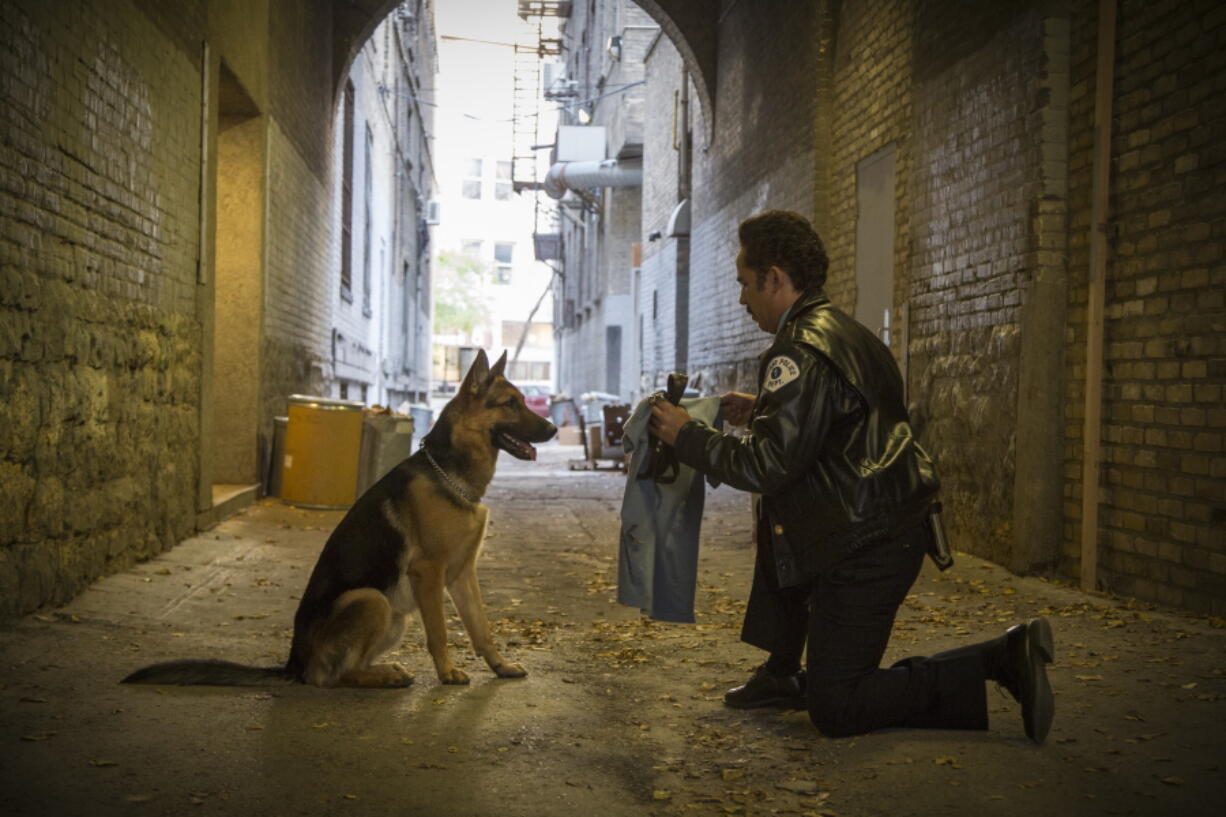 John Ortiz addresses a German shepherd in a scene from &quot;A Dog&#039;s Purpose.&quot; (Joe Lederer/Universal Studios)