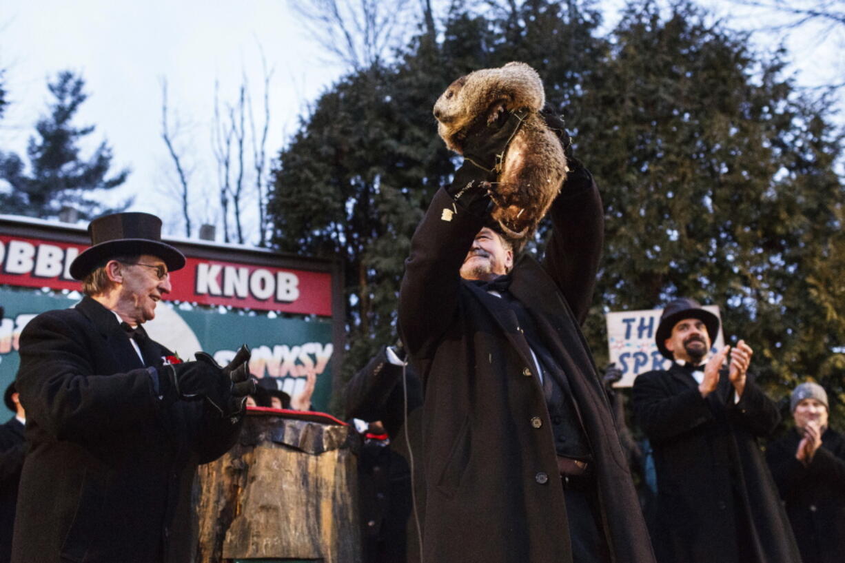 Groundhog Club handler John Griffiths holds Punxsutawney Phil, the weather prognosticating groundhog, during the 131st celebration of Groundhog Day on Gobbler&#039;s Knob in Punxsutawney, Pa., on Thursday. Phil&#039;s handlers said that the groundhog has forecast six more weeks of winter weather.