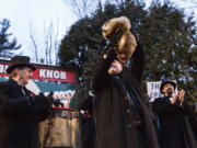 Groundhog Club handler John Griffiths holds Punxsutawney Phil, the weather prognosticating groundhog, during the 131st celebration of Groundhog Day on Gobbler&#039;s Knob in Punxsutawney, Pa., on Thursday. Phil&#039;s handlers said that the groundhog has forecast six more weeks of winter weather.