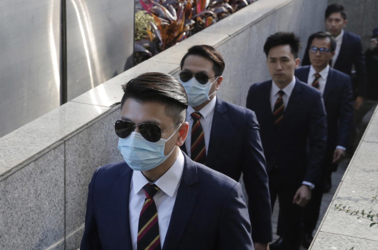 Five of the seven Hong Kong police officers, from left, Police Constable Wong Wai-ho, Police Constable Lau Hing-pui, Senior Inspector Lau Cheuk-ngai, Sergeant Pak Wing-bun and Police Constable Kwan Ka-ho arrive Tuesday in the District Court in Hong Kong as they were charged with assaulting a pro-democracy activist in an incident on Oct. 15 2014. Seven Hong Kong police officers have been sentenced Friday, Feb. 27 to two years in prison for assaulting a pro-democracy activist at the height of 2014 protests.