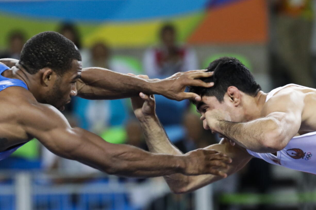 United States&#039; Jordan Ernest Burroughs, left, competes against Uzbekistan&#039;s Bekzod Abdurakhmonov on Aug. 19, 2016, during the men&#039;s 74-kg freestyle wrestling competition at the 2016 Summer Olympics in Rio de Janeiro, Brazil. Iran on Friday banned U.S. wrestlers from this month&#039;s Freestyle World Cup in response to President Donald Trump&#039;s executive order forbidding visas for Iranians, the official IRNA news agency reported.