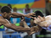 United States&#039; Jordan Ernest Burroughs, left, competes against Uzbekistan&#039;s Bekzod Abdurakhmonov on Aug. 19, 2016, during the men&#039;s 74-kg freestyle wrestling competition at the 2016 Summer Olympics in Rio de Janeiro, Brazil. Iran on Friday banned U.S. wrestlers from this month&#039;s Freestyle World Cup in response to President Donald Trump&#039;s executive order forbidding visas for Iranians, the official IRNA news agency reported.