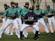 Seattle Mariners pitcher Felix Hernandez, front center, stretches with teammates participates during spring training baseball practice Wednesday, Feb. 15, 2017, in Peoria, Ariz.