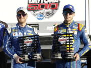 Dale Earnhardt Jr., left, and Chase Elliott display their front row trophies after qualifying for the top two positions in the NASCAR Daytona 500 auto race at Daytona International Speedway, Sunday, Feb. 19, 2017, in Daytona Beach, Fla.