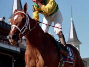 Jockey Chris Antley gestures aboard Charismatic after crossing the finish line to capture the 125th running of the Kentucky Derby in Louisville, Ky., on May 1, 1999. Former Kentucky Derby and Preakness Stakes winner Charismatic has died at a thoroughbred retirement farm in Kentucky. Old Friends farm says the chestnut horse that won the first two legs of the Triple Crown in 1999 was found dead in his stall Sunday, Feb. 19, 2017.