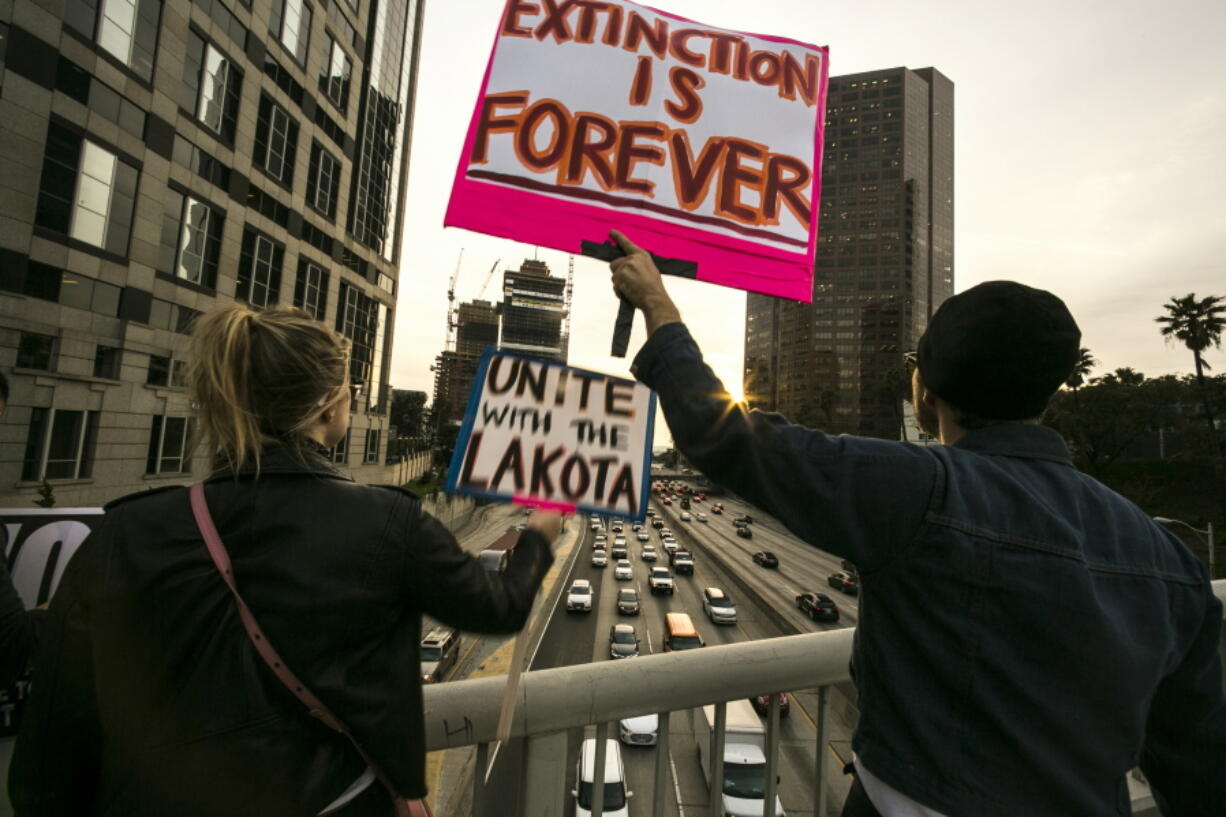 Opponents of the Dakota Access pipeline protest on an overpass on the Interstate 110 freeway, in response to the Army Corps of Engineers saying it will clear the way for completion of the disputed $3.8 billion project to carry North Dakota oil to Illinois, outside the Army&#039;s offices in Los Angeles on Wednesday. Dallas-based Energy Transfer Partners, ETP on Wednesday got final permission from the Army to proceed with a crossing of the Missouri River in southern North Dakota. The tribe fears a pipeline leak could contaminate its drinking water.