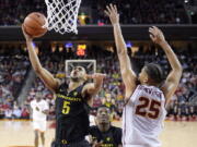 Oregon guard Tyler Dorsey, left, shoots as Southern California forward Bennie Boatwright defends during the second half of an NCAA college basketball game, Saturday, Feb. 11, 2017, in Los Angeles. Oregon won 81-70. (AP Photo/Mark J.