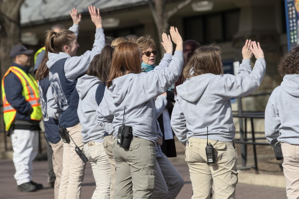 Animal keepers wave goodbye to Bao Bao, the beloved 3-year-old panda, Tuesday at the National Zoo. (J.