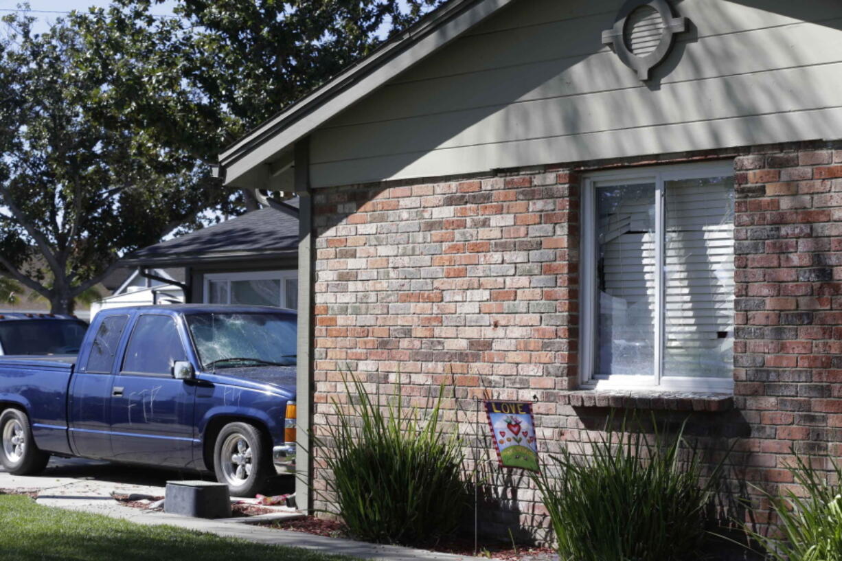 A vandalized truck and broken windows are seen Thursday in a home in Anaheim, Calif. An off-duty California officer who didn&#039;t want teens walking across his lawn fired his gun during a struggle with a 13-year-old boy and other youths, igniting unruly protests after video of the fight surfaced and two boys were arrested.