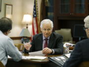 Washington Insurance Commissioner Mike Kreidler, center, conducts a meeting in his office in 2017 at the Capitol in Olympia. (Ted S.