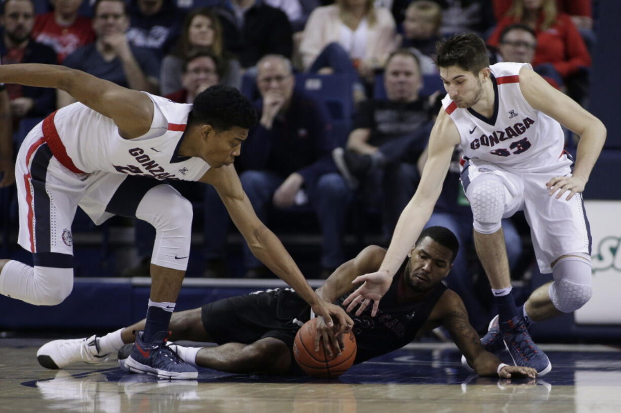 Gonzaga&#039;s Rui Hachimura, left, and Killian Tillie try to get the away from Santa Clara&#039;s KJ Feagin during the second half Saturday. Gonzaga won 90-55.