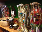 Statues of La Santa Muerte are displayed at the Masks y Mas art store in Albuquerque, N.M.