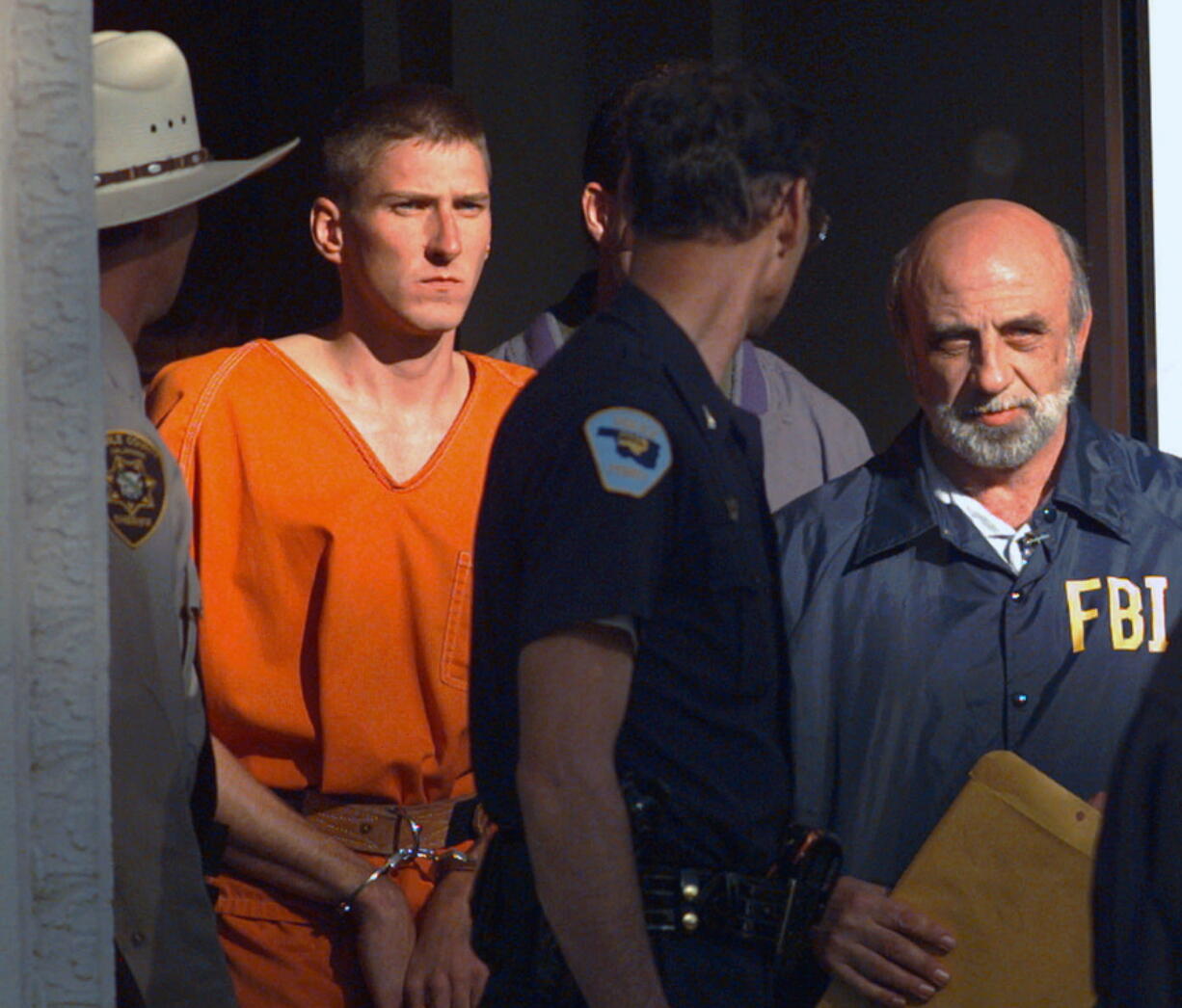 Timothy James McVeigh is led out of the Noble County Courthouse by state and federal law enforcement officials April 21, 1995, in Perry, Okla., after being identified as a suspect in the bombing of the Oklahoma City Federal building.