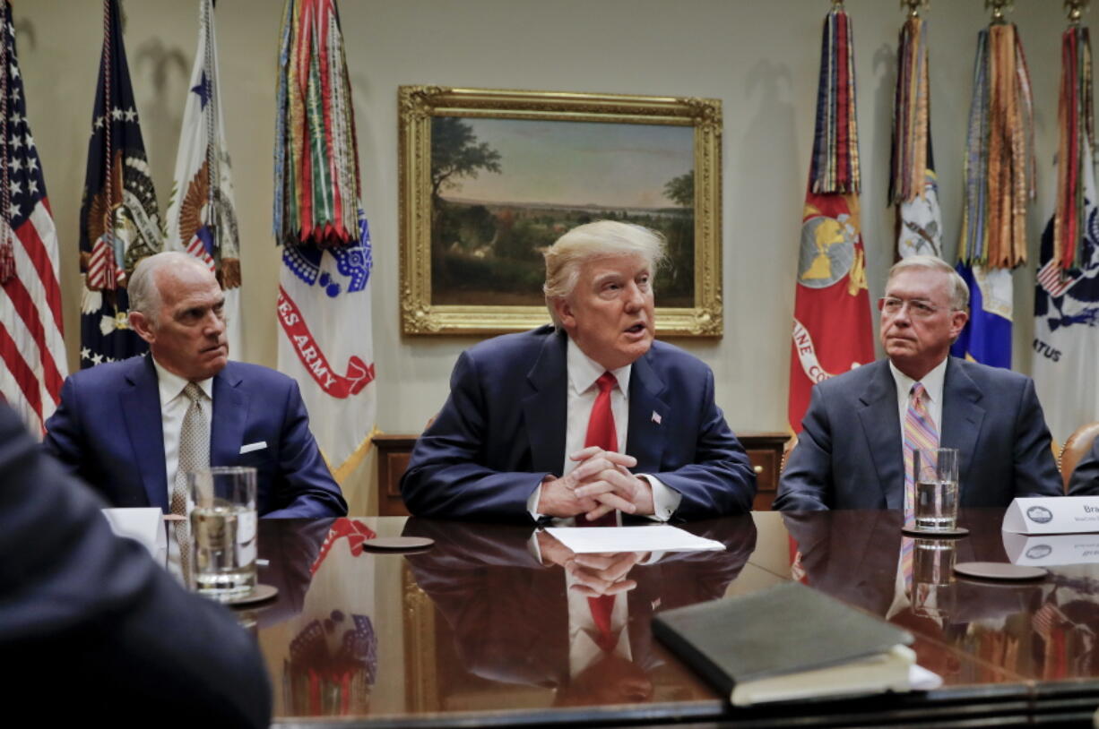 President Donald Trump, flanked by Independence Blue Cross CEO Daniel J. Hilferty, left, and Blue Cross and Blue Shield of North Carolina CEO Brad Wilson, speaks in Washington.