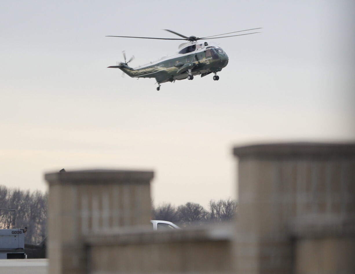 Marine One, with President Donald Trump aboard, lands Wednesday at Dover Air Force Base in Delaware. Trump traveled to Dover, Del., to meet with the family of William &quot;Ryan&quot; Owens, 36, the U.S. service member who was killed in a weekend raid in Yemen.