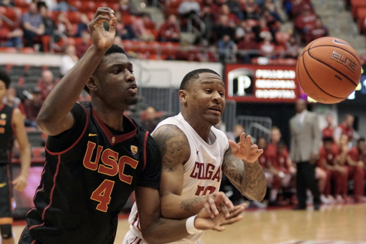 Southern California forward Chimezie Metu (4) and Washington State guard Charles Callison battle for the ball in the second half of an NCAA college basketball game, Saturday, Feb. 4, 2017, in Pullman, Wash.