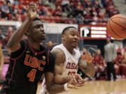 Southern California forward Chimezie Metu (4) and Washington State guard Charles Callison battle for the ball in the second half of an NCAA college basketball game, Saturday, Feb. 4, 2017, in Pullman, Wash.