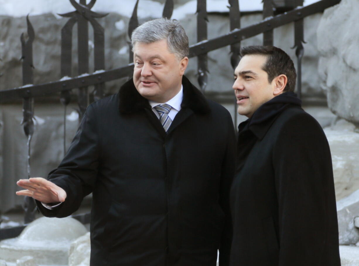 Ukraine&#039;s President Petro Poroshenko, left, and Greece&#039;s Prime Minister Alexis Tsipras speak during a meeting in Kiev, Ukraine, on Thursday.