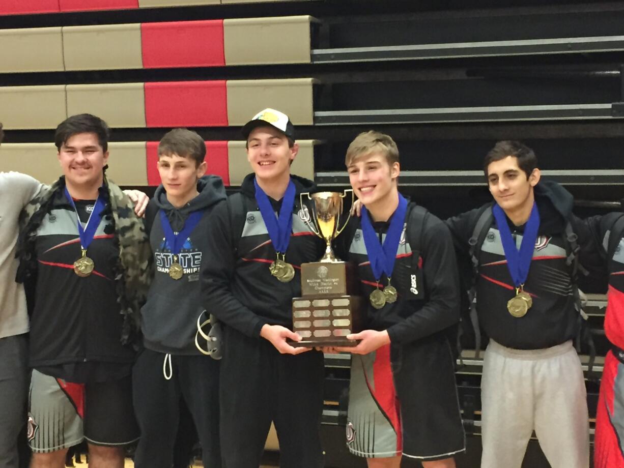 The Union wrestling team celebrates its 4A GSHL District team title on Saturday at Camas High School.