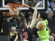 Oregon&#039;s Dillon Brooks, right, dunks over Utah&#039;s David Collette during the second half of an NCAA college basketball game Thursday, Feb. 16, 2017, in Eugene, Ore.