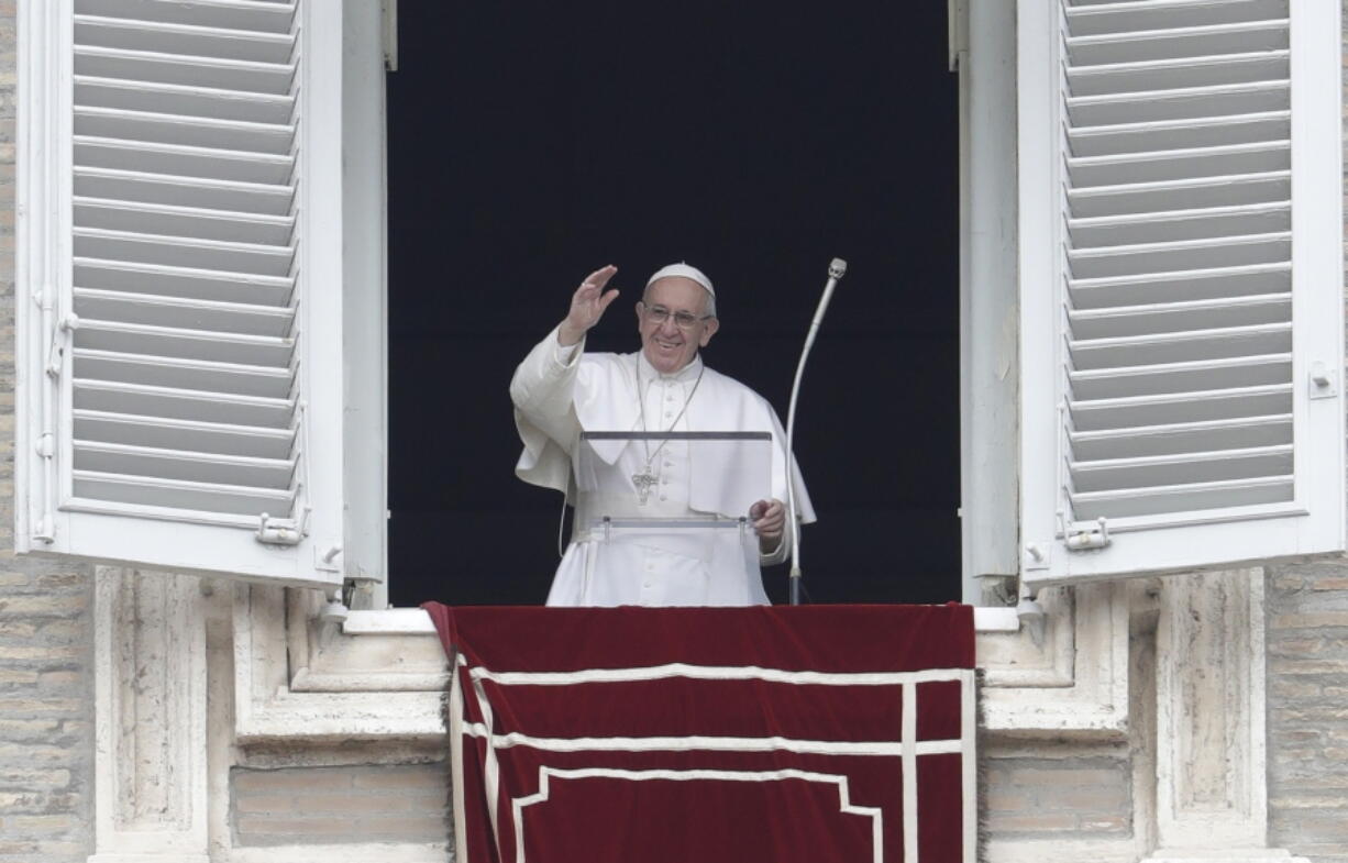 Pope Francis waves from his studio window overlooking St. Peter&#039;s Square during his Angelus prayer, at the Vatican, Sunday, Feb. 5, 2017.