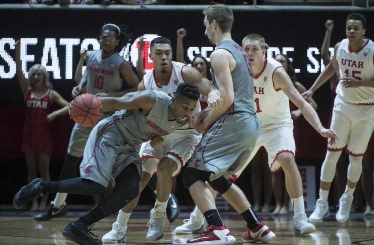 Washington State&#039;s Ike Iroegbu drives around Utah&#039;s Sedrick Barefield during an NCAA college basketball game in Salt Lake City, Thursday, Feb. 9, 2017.