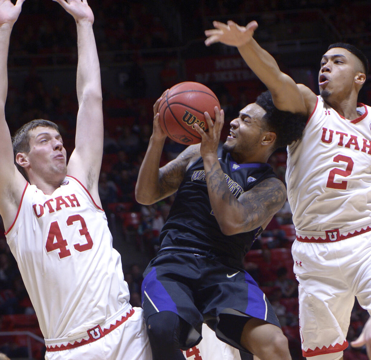 Utah forward Jakub Jokl (43) and guard Sedrick Barefield (2) stop Washington guard David Crisp (1) during an NCAA college basketball game Saturday, Feb. 11, 2017, in Salt Lake City.