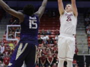 Washington State forward Josh Hawkinson (24) shoots against Washington forward Noah Dickerson (15) during the second half of an NCAA college basketball game in Pullman, Wash., Sunday, Feb. 26, 2017. Washington State won 79-71.